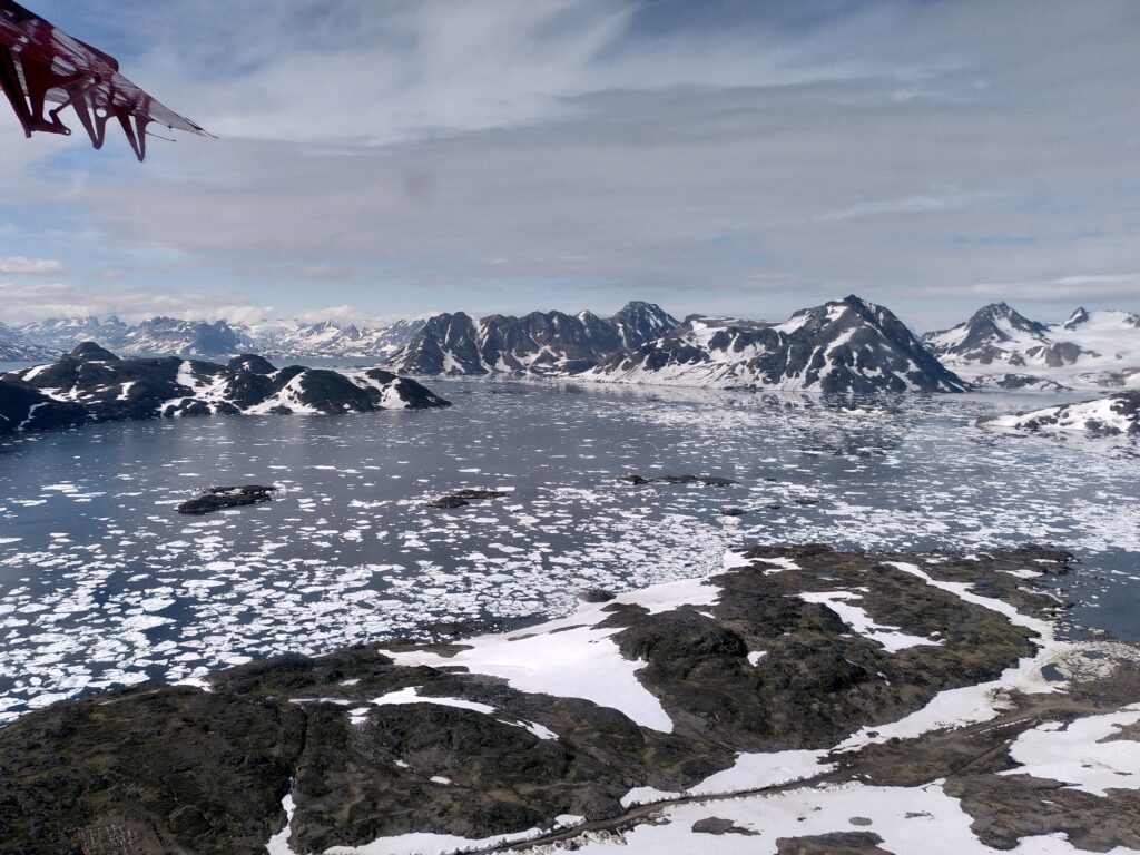 View of East Greenland, snowcovered mountains and sea ice.